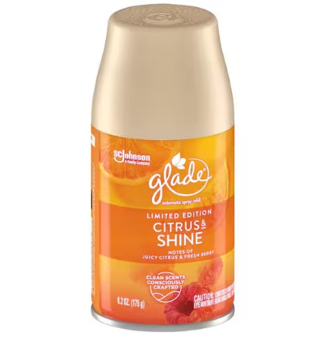 A bottle of GLADE citrus shine air freshener with a beige cap and a label featuring orange and green colors and citrus fruit images. The label indicates it is a limited edition.